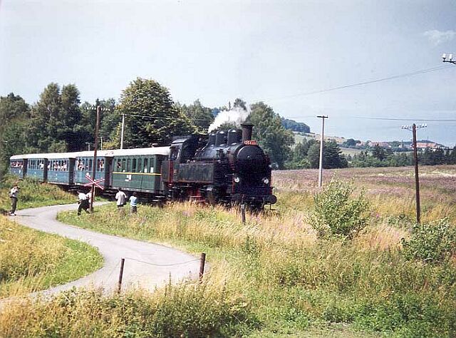 Zpožděný protokolární vlak v čele s 354.1217 před zastávkou Konstantinovy Lázně.